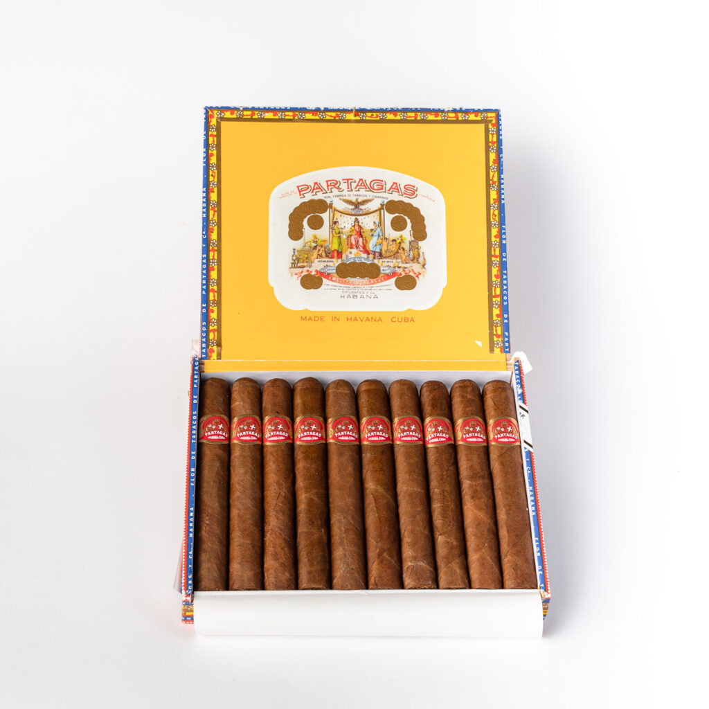 Partagas Cuban cigars in a colorful open box.