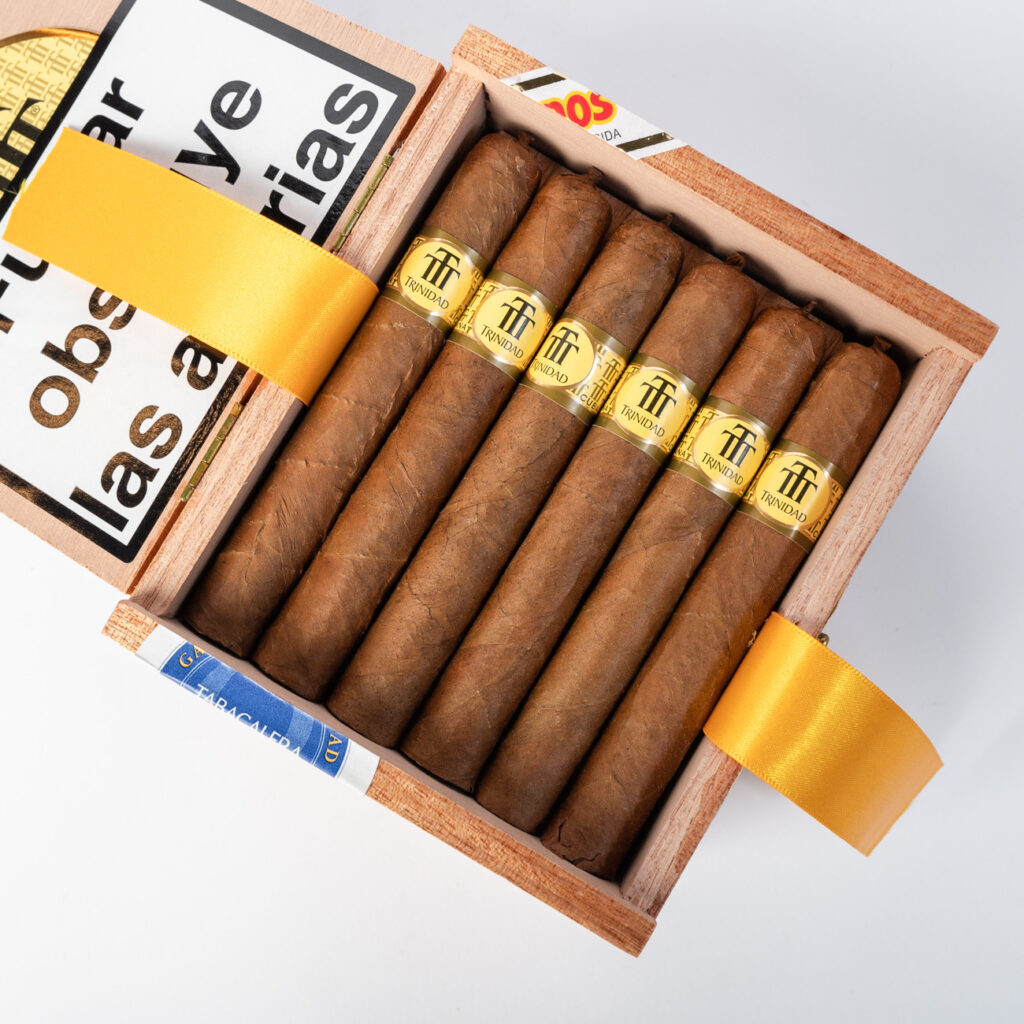 Trinidad cigars in a wooden box with a gold label.