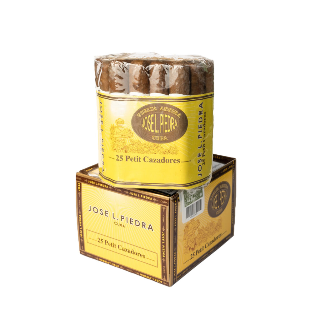 José L. Piedra Petit Cazadores cigars, bold yellow packaging, rustic appeal.